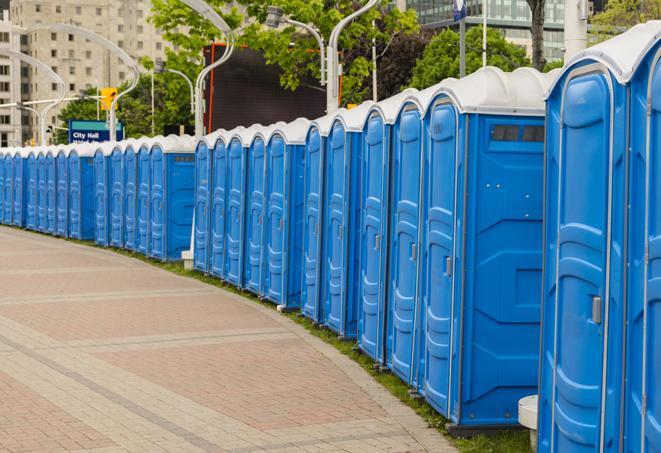 a row of portable restrooms set up for a large athletic event, allowing participants and spectators to easily take care of their needs in Ash Fork, AZ